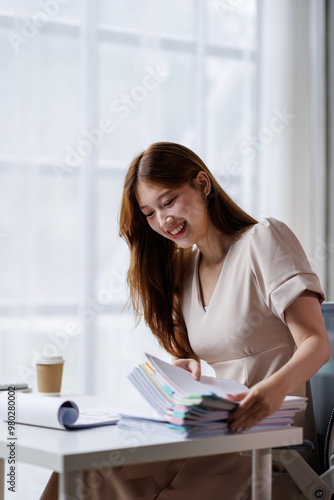 Adult businesswoman or auditor examining documents and laptop. financial document reports, detail-focused work concept