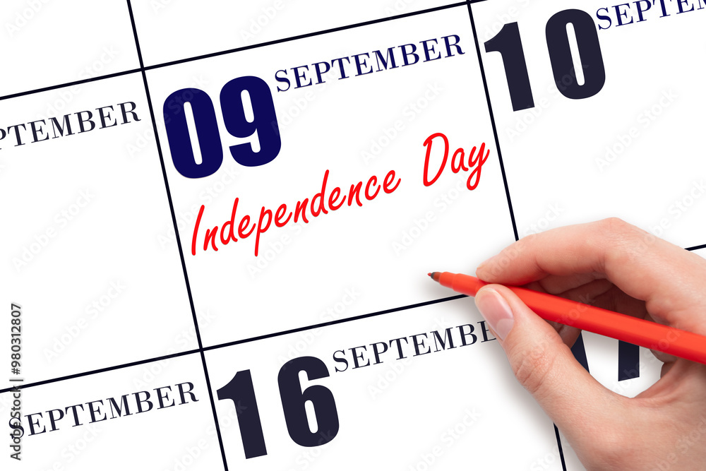 September 9. Hand writing text Independence Day on calendar date. Save the date. September 9. Hand writing text Independence Day on calendar date. Save the date.