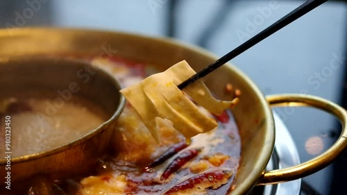 chopsticks picking beef aorta artery in boiling sichuan hot pot chinese cuisine video