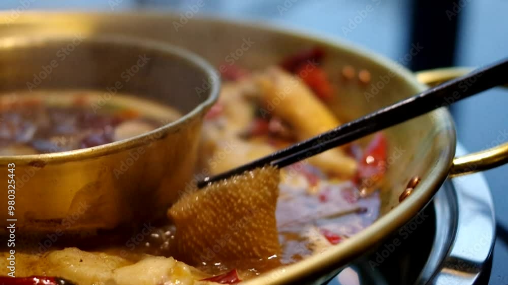 Putting beef tripe omasum in boiling hot pot spicy Chinese food Sichuan cuisine footage Putting beef tripe omasum in boiling hot pot spicy Chinese food Sichuan cuisine footage