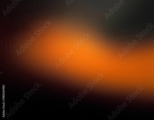  A diffused orange spotlight creates a circular shape on a dark surface