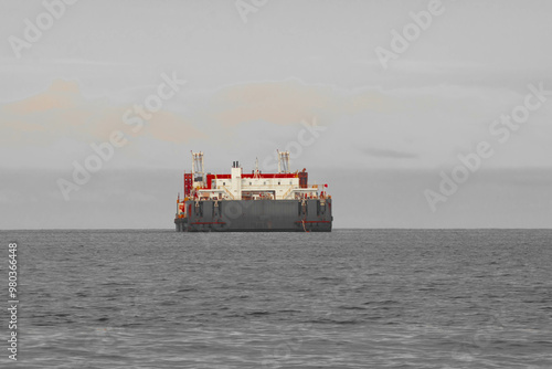 Photography As the mountains stand tall in the port, the fishermen's boat sets sail