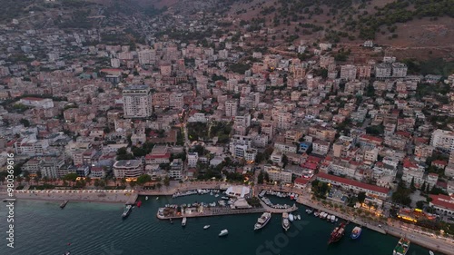 Wallpaper Mural Saranda, albania, as the coastal town glows at sunset with boats in the harbor, aerial view Torontodigital.ca