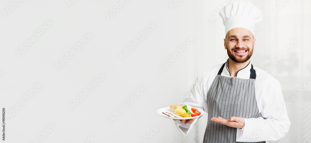 Fish Recipes. Cheerful Chef Man Holding Plate With Roasted Salmon Steak Serving Dish Standing In Kitchen. Selective Focus