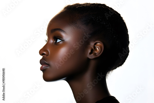 Side view portrait of a joyful African woman with glowing dark skin, captured in a close-up against a plain white background