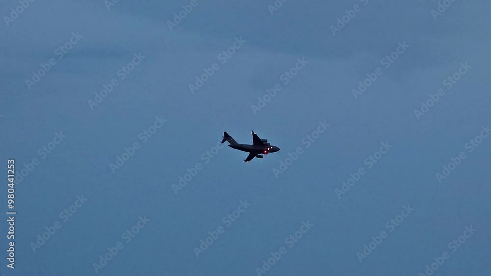 A solitary airplane flies through a clear blue sky. Perfect for travel, aviation, or transportation footage. A solitary airplane flies through a clear blue sky. Perfect for travel, aviation, or transportation footage.