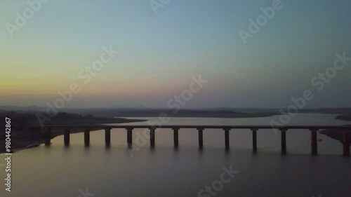 Wallpaper Mural Down to top shot of bridge joining lands on either side of lake in Hyderabad, India during sunset. 4k. Aerial view. Torontodigital.ca