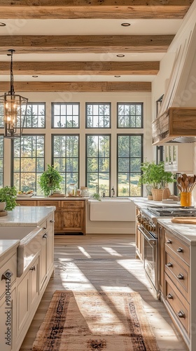 rusticmodern kitchen with warm wood beams gleaming quartz island farmhouse sink and large windows flooding the space with natural light photo