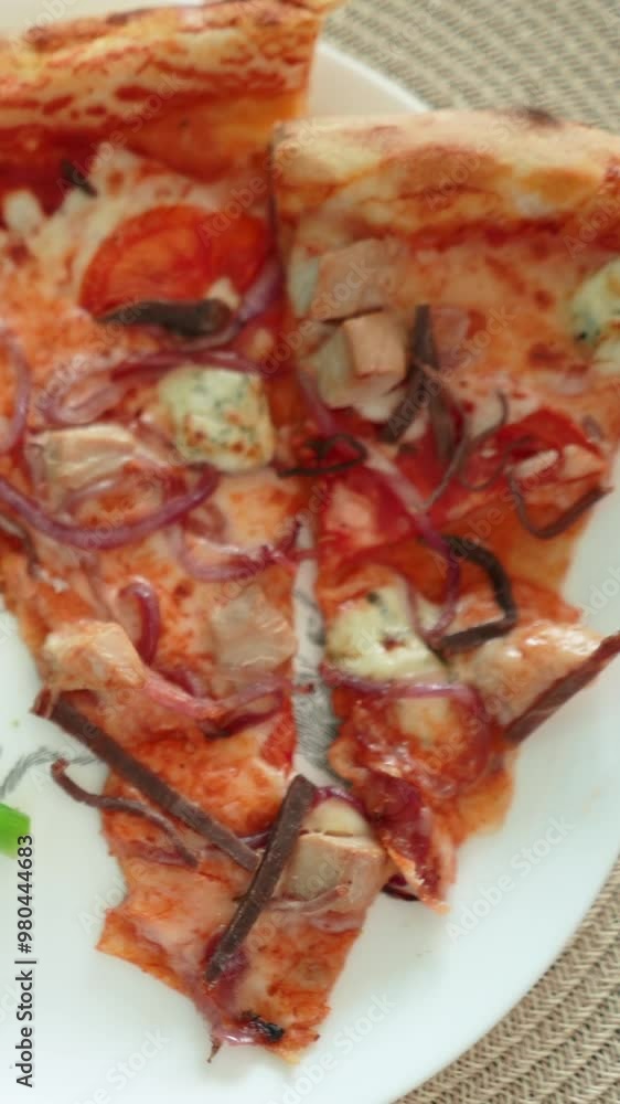 delicious appetizing pizza with meat and cheese lies in a plate with vegetables. Healthy or unhealthy food. Fresh healthy carrots, greens, broccoli, cabbage delicious appetizing pizza with meat and cheese lies in a plate with vegetables. Healthy or unhealthy food. Fresh healthy carrots, greens, broccoli, cabbage