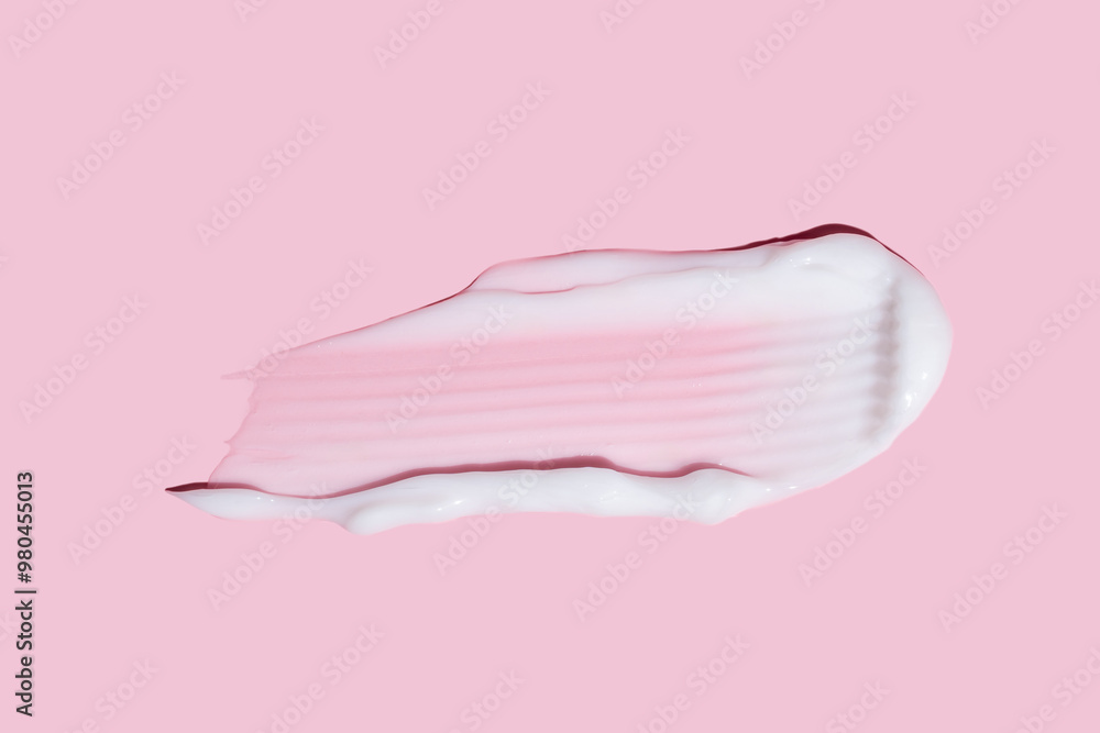 Liquid cream cosmetic smudge drops texture on pink background. cosmetic smears cream texture. skin care product stroke flat lay, cream with hyaluronic acid Liquid cream cosmetic smudge drops texture on pink background. cosmetic smears cream texture. skin care product stroke flat lay, cream with hyaluronic acid