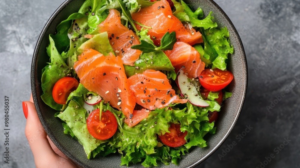 Healthy Young woman holding Salted salmon salad bowl with fresh green lettuce,smoked salmon,tomato,Ketogenic,diet lunch bowl,enjoy eat clean vegetables after exercise,Healthy food concept. Healthy Young woman holding Salted salmon salad bowl with fresh green lettuce,smoked salmon,tomato,Ketogenic,diet lunch bowl,enjoy eat clean vegetables after exercise,Healthy food concept.