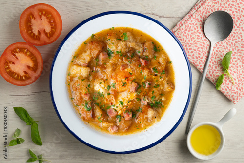 Castilian soup with vegetables, bread croutons and egg. Top view table with decorations.