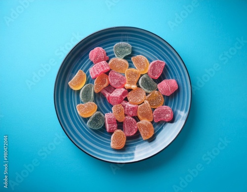 Various gummy candies on a blue plate, postmodern mashup style, vibrant colors, playful vibe. photo