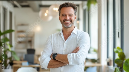 A successful entrepreneur standing in a modern office, arms crossed, smiling confidently Close-up photo with clean background