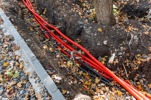 Wallpaper Mural Underground Installation of Red and Black Electrical Cables Amidst a Beautiful Autumn Landscape, Capturing the Essence of Nature in Construction Torontodigital.ca