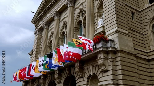 Parliament Building or Federal Palace with All Swiss Canton Flags Waving in the Wind on the Facade in City of Bern, Canton Bern, Switzerland.