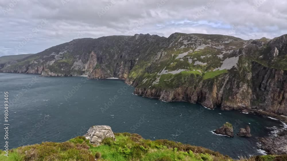 Slieve League cliffs in Ireland are featured in a panoramic video, moving from right to left. The footage highlights the towering cliffs and deep blue waters of the Atlantic Slieve League cliffs in Ireland are featured in a panoramic video, moving from right to left. The footage highlights the towering cliffs and deep blue waters of the Atlantic