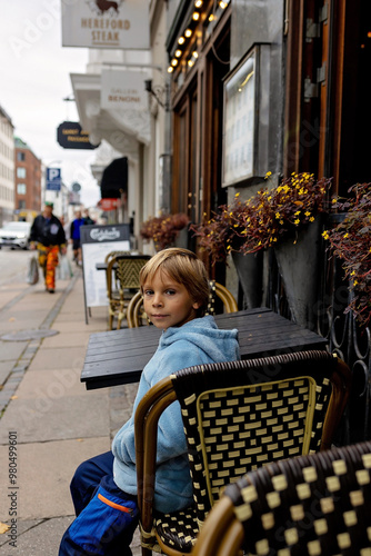 Family with children and pet dog, kids and adults visiting Coppenhagen , capital city of Denmarn during summer photo