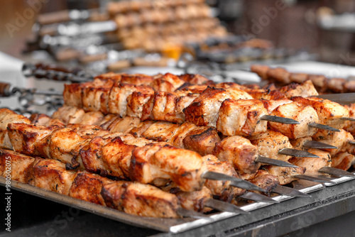Obraz na płótnie Pork kebab (shish kebab) in close-up. Meat fried on fire (barbecue) on skewers on the market counter. Delicious and mouth-watering shashlik w salonie