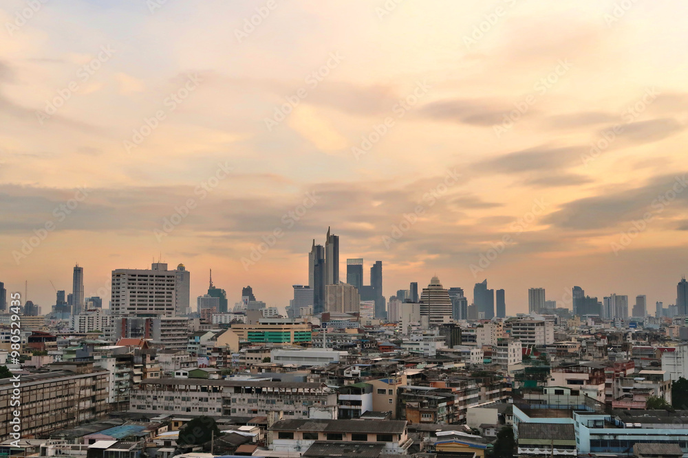 Obraz premium View onto the skyline of Bangkok before sunset, skyscrapers under a cloudy sky, Thailand