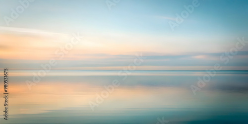 Serene Seascape: A tranquil and abstract sunset over a calm ocean, capturing the ethereal beauty of nature's soft hues in a dreamy, blurred backdrop. 