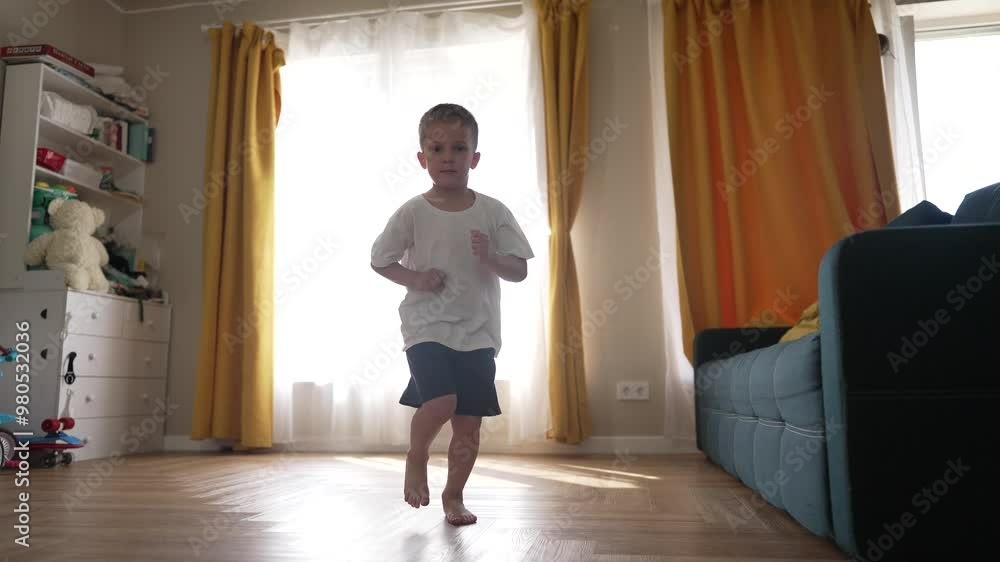 Happy child running at home. boy running barefoot indoors. child living his dream playful freedom. Bright room with toys. Energetic child running in cozy home. Boy enjoying dreamlike moments indoors. Happy child running at home. boy running barefoot indoors. child living his dream playful freedom. Bright room with toys. Energetic child running in cozy home. Boy enjoying dreamlike moments indoors.