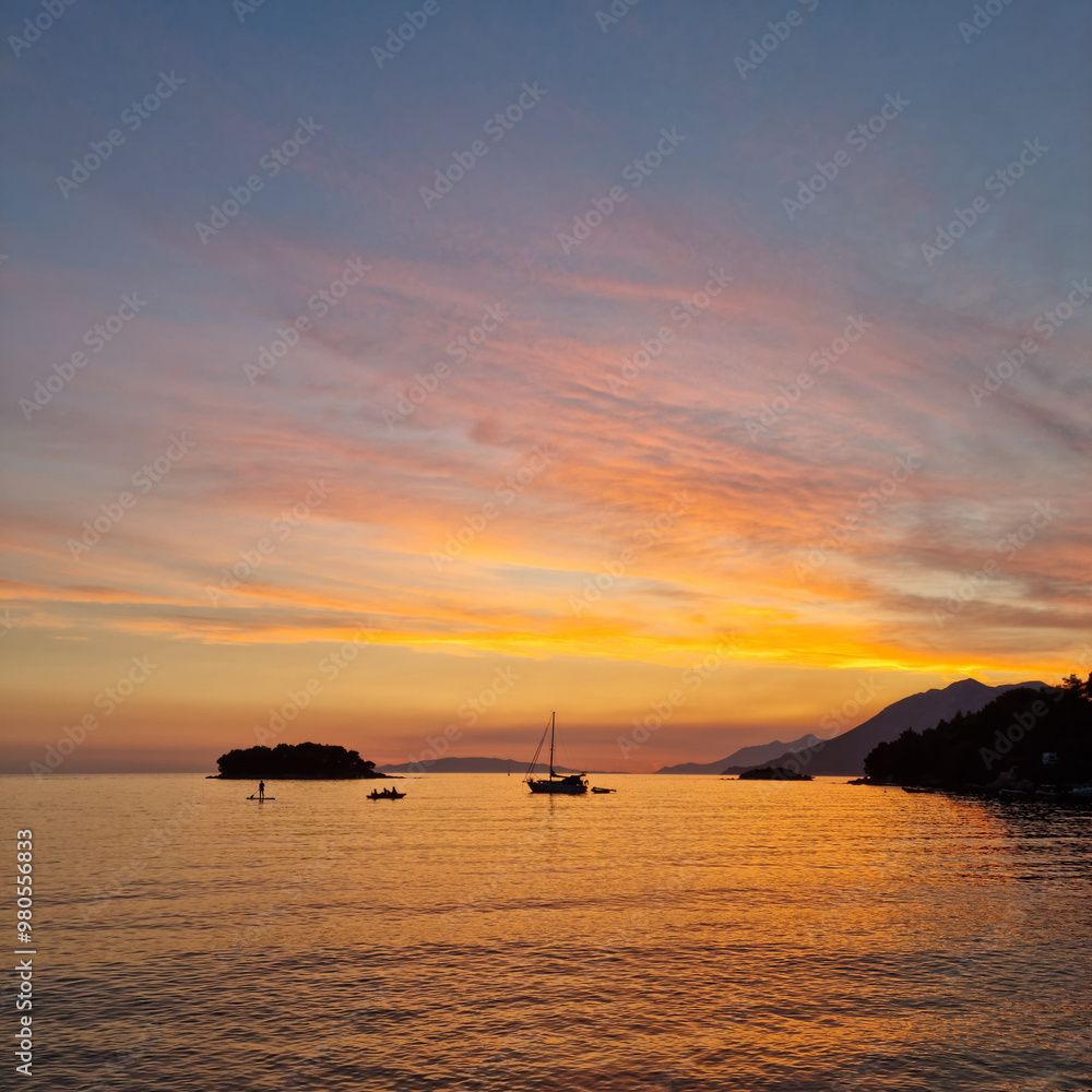 Vucine bay in Zuljana on the Peljesac peninsula and Kosmac islet in the colors of the setting sun Vucine bay in Zuljana on the Peljesac peninsula and Kosmac islet in the colors of the setting sun