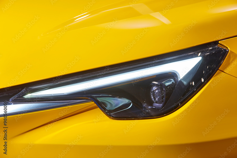 Yellow car headlight detail. Elegant design car lights. Motor industry