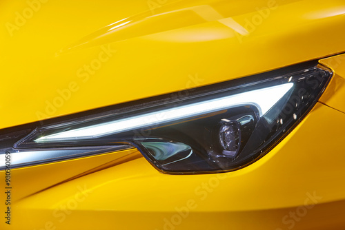 Obraz na płótnie Yellow car headlight detail. Elegant design car lights. Motor industry w salonie
