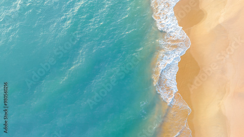 Fototapeta Naklejka Na Ścianę i Meble -  Beach top view of soft blue ocean wave on clean sandy beach and relaxing aerial scene, summer vacation holiday template banner. Waves surf with blue ocean lagoon