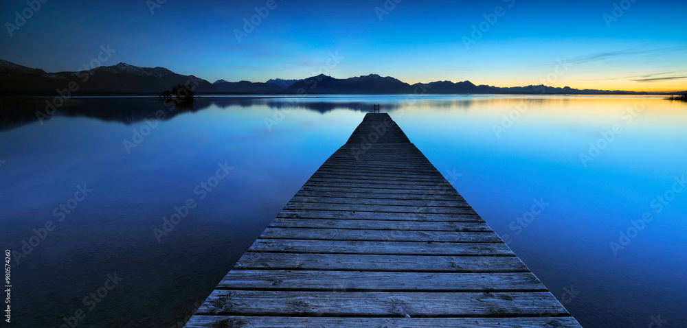 Fototapeta premium Panorama of Wooden Pier by Lake Chiemsee at Sunset against the Alps, Bavaria, Germany