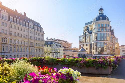 A scenic view of modern buildings along Balchug street in the historical center of Moscow, featuring flower-filled terraces in the foreground. photo