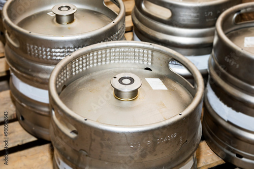A meticulously stacked collection of beer kegs prepared and ready for distribution delivery