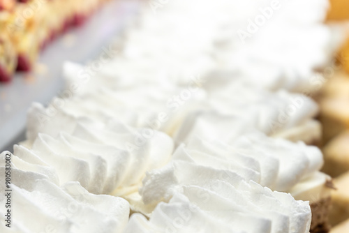 Cream-topped pastries. Close-up. Restaurant menu.