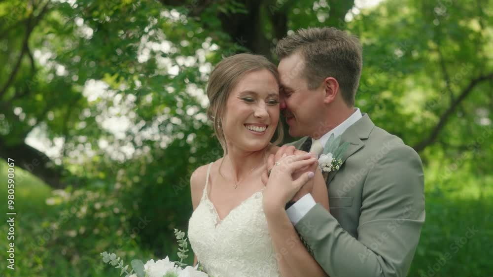 Bride and Groom Standing in Forest Holding Hands While Smiling at Each Other Bride and Groom Standing in Forest Holding Hands While Smiling at Each Other