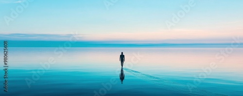 A serene landscape featuring a solitary figure walking on tranquil water at sunset, reflecting an atmosphere of peace and solitude.