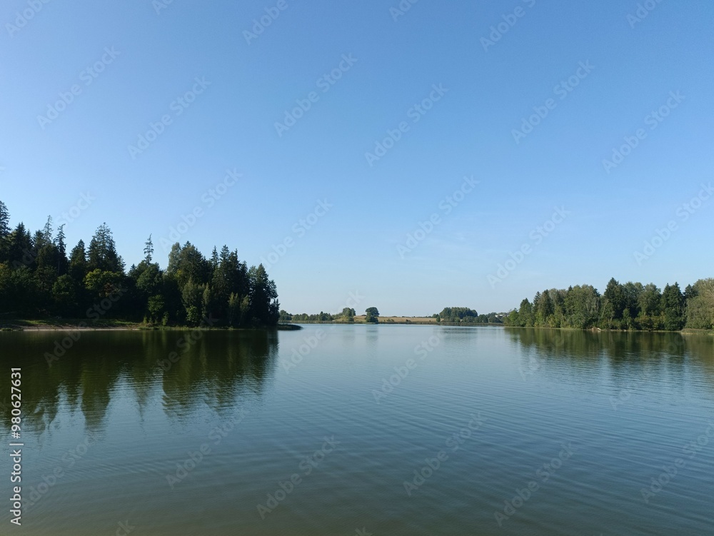 Bubiai lake during sunny day. Sunny day with white and gray clouds in blue sky. Wavy lake. Horizon over water. Bubiu ezeras. Bubiai lake during sunny day. Sunny day with white and gray clouds in blue sky. Wavy lake. Horizon over water. Bubiu ezeras.