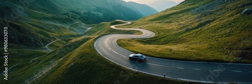 Aerial view of car and winding road in high mountain pass. Serpentine curvy road
