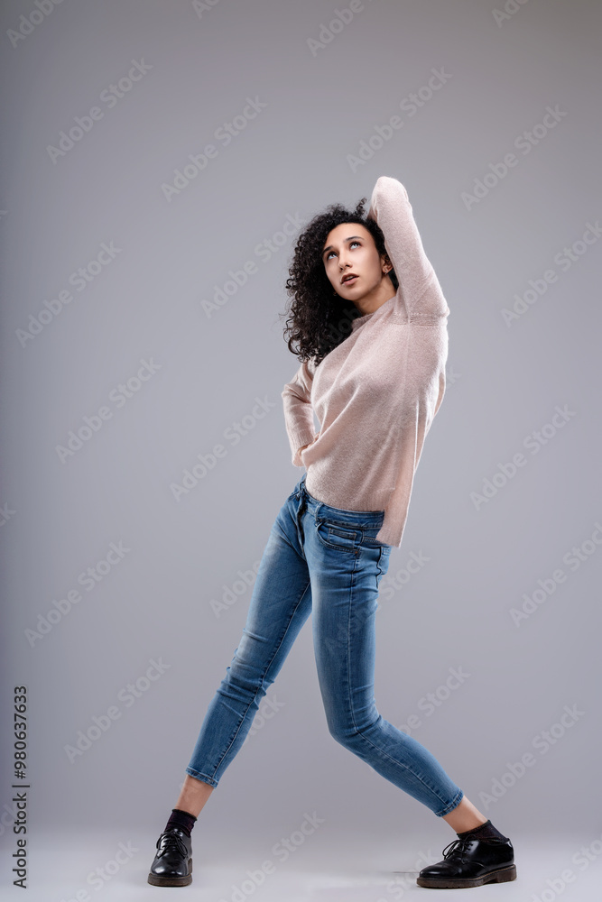 Fashion model posing with hand in hair and looking up Fashion model posing with hand in hair and looking up
