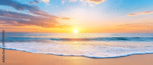 A breathtaking sunrise over a calm ocean, with gentle waves lapping at the sandy shore, creating a peaceful and serene atmosphere.