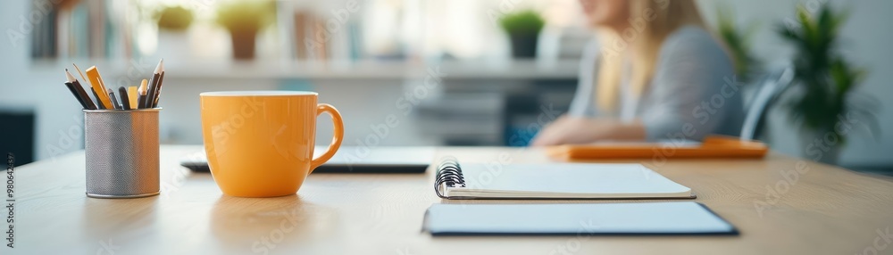 Fototapeta premium Professional woman on a virtual meeting, with an organized workspace and notebook, reflecting efficiency and effective communication from home