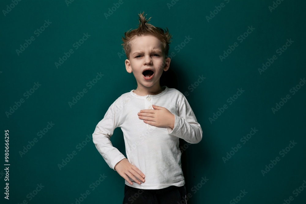 Young Boy Standing in Front of Green Wall Young Boy Standing in Front of Green Wall