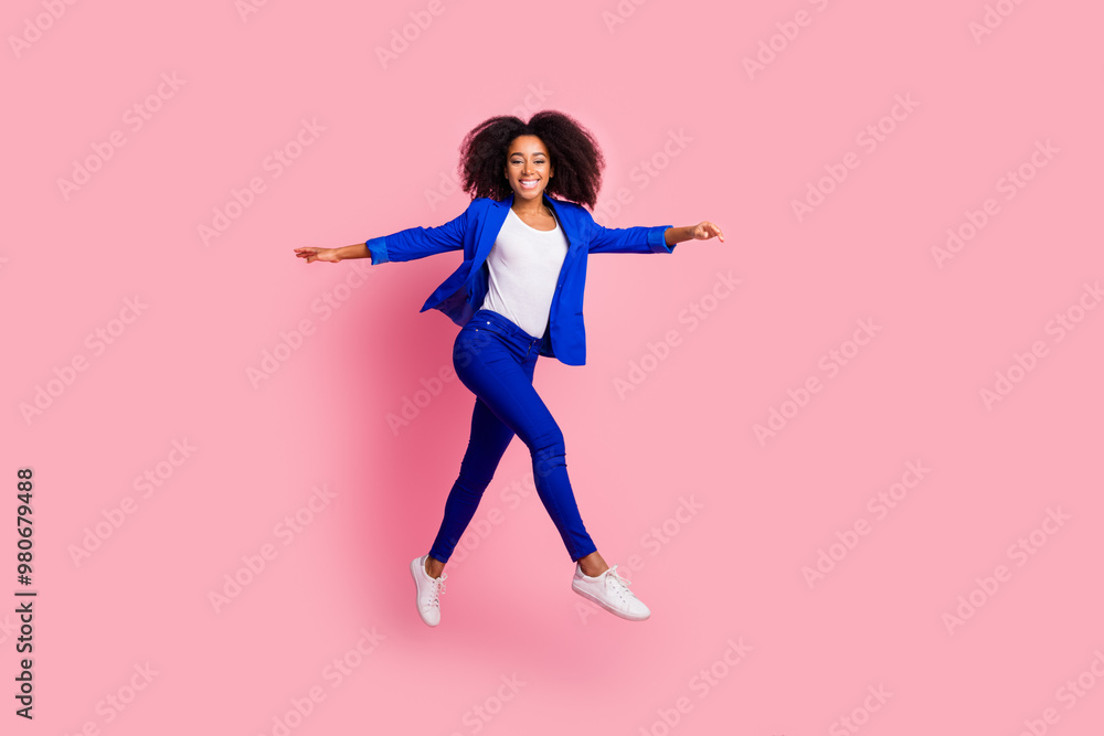 Photo of adorable nice positive girl wear stylish blue clothes walk isolated on pink color background Photo of adorable nice positive girl wear stylish blue clothes walk isolated on pink color background