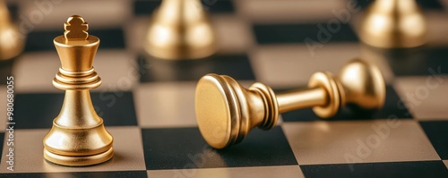 Golden chess pieces arranged in a checkmate position, with the golden king knocked over, symbolizing strategic victory