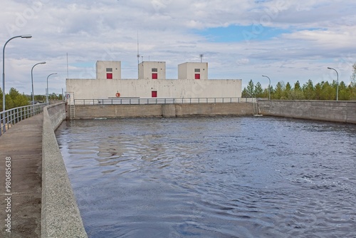 Skogfoss powerplant on Pasvik river in cloudy spring weather, Norway. photo