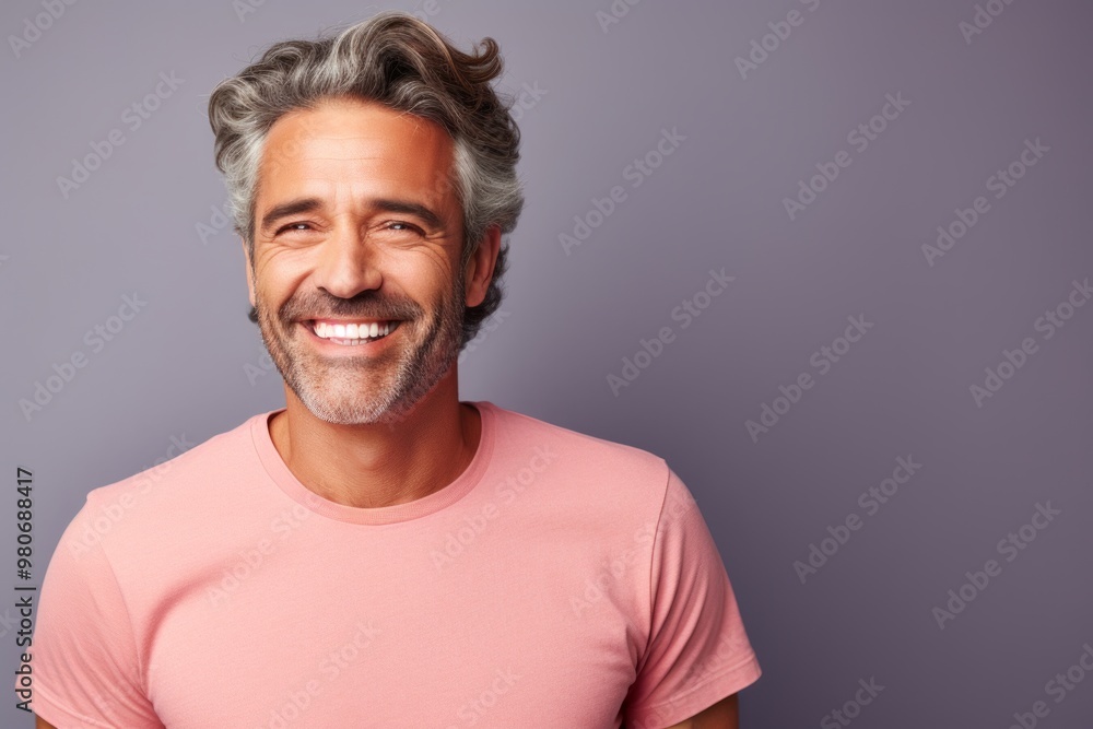 Portrait of a cheerful man in his 40s donning a trendy cropped top over pastel gray background Portrait of a cheerful man in his 40s donning a trendy cropped top over pastel gray background