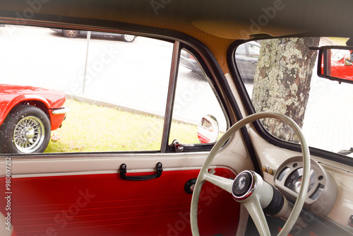 The interior of an old red retro car. Concept of love for retro style, vintage stuff, car enthusiasts photo