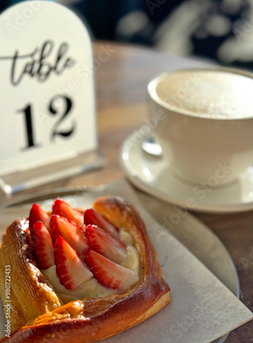 Strawberry danish pastry and coffee at a cafe