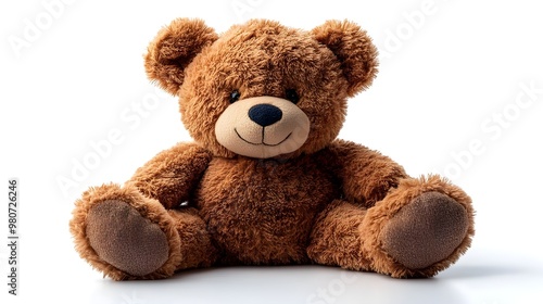 a brown teddy bear sitting on a white surface