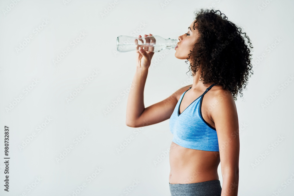 © StarDweller/peopleimages.com - Woman, training and drinking water in studio with fitness for hydration, break and thirsty of exercise with mockup. Athlete, person or liquid bottle for relax, wellness or refresh on white background